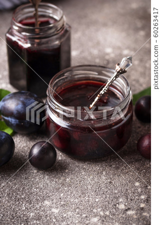 Jar with homemade plum jam 60263417