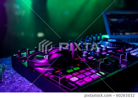 DJ music mixer and professional headphones in the nightclub 60263832