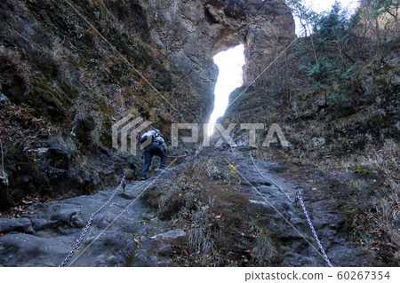 Female climber climbing the second stone gate of Myogi Mountain Female climber climbing the second stone gate of Myogi Mountain 60267354