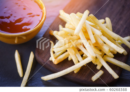 french fries ketchup in wooden board with black french fries ketchup in wooden board with black 60268388