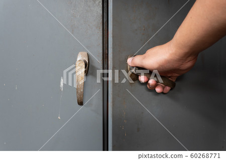 Hand of men is opening old and rusty steel cabinet Hand of men is opening old and rusty steel cabinet 60268771