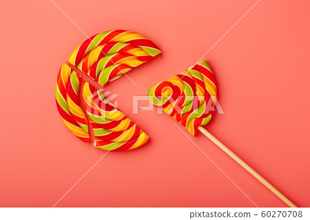 Lollipop broken into pieces on pink background, Lollipop broken into pieces on pink background, 60270708