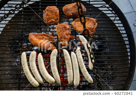 Barbecue grill bbq on coal charcoal grill with steaks bratwurst sausages and meat delicious summer meal 60272841