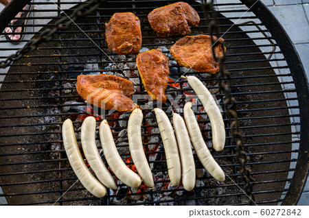 Barbecue grill bbq on coal charcoal grill with steaks bratwurst sausages and meat delicious summer meal 60272842