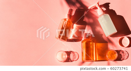 Various cosmetic products on pink coral. Flat lay Various cosmetic products on pink coral. Flat lay 60273741