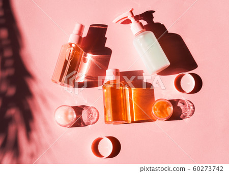 Various cosmetic products on pink coral. Flat lay Various cosmetic products on pink coral. Flat lay 60273742