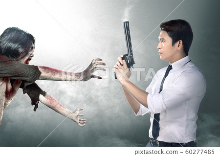 Asian businessman with the gun on his hand face the zombies 60277485