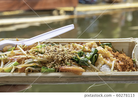 Fried noodle with spring onion and bean sprouts in bamboo. 60278113