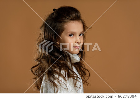 little girl in white sweater looking to camera little girl in white sweater looking to camera 60278394