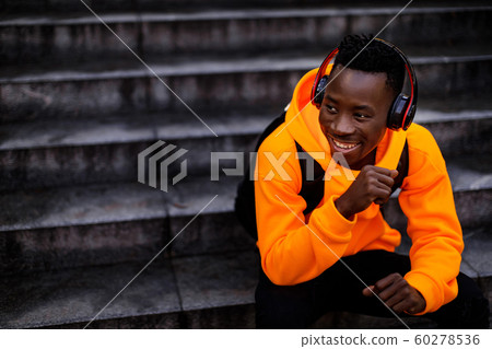 african-american man in wireless headphones listening music african-american man in wireless headphones listening music 60278536