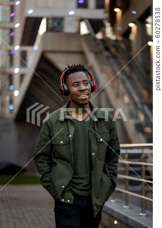 african-american man in wireless headphones listening music 60278538
