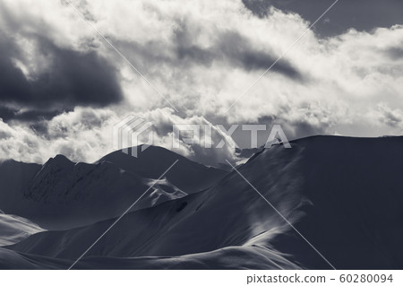 Off piste slope in sunlight clouds at evening Off piste slope in sunlight clouds at evening 60280094