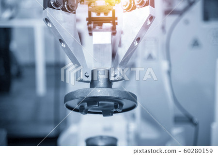 The  robotic arm handle the metal casting parts. 60280159