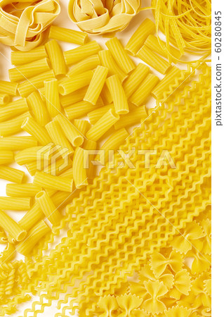 Italian pasta texture, a flatlay overhead shot on a white background. Rigatoni, fusilli, farfalle and others 60280845