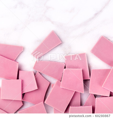Ruby chocolate, overhead square shot on a white marble background with copyspace Ruby chocolate, overhead square shot on a white marble background with copyspace 60280867
