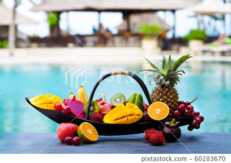Tropical fruits assortment in wooden boat. Outdoor tropical background. Copy space. 60283670