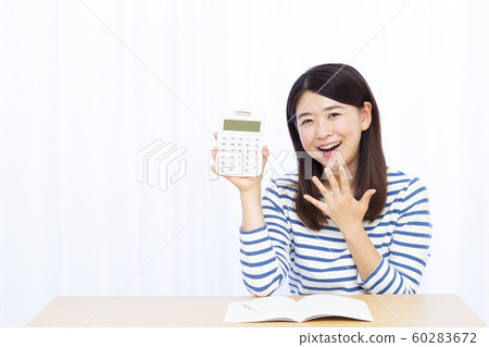 Thirties Woman and Calculator Thirties Woman and Calculator 60283672