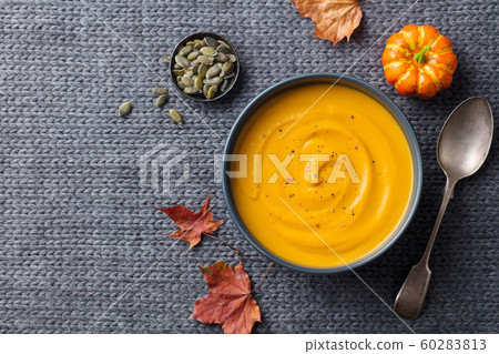 Pumpkin, carrot cream soup. Grey textile background. Copy space. Top view. 60283813