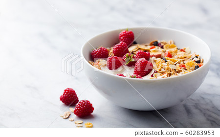 Healthy breakfast. Fresh granola, muesli with yogurt and berries. Marble background. Close up. Copy space. Healthy breakfast. Fresh granola, muesli with yogurt and berries. Marble background. Close up. Copy space. 60283953