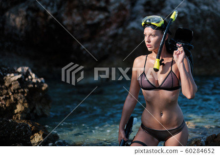 Aqua woman diver spearfishing gun. 60284652