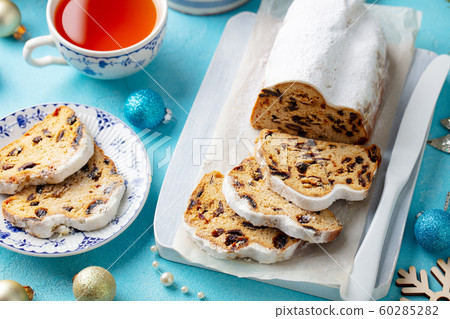Christmas stollen cake with icing sugar, marzipan and raisins. Traditional Dresdner christ pastry. 60285282