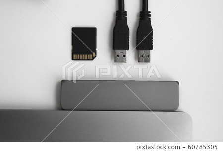 Laptop with USB Type-C adapter with pluged USB cables and SD card. The USB adapter under the Type-C connector for laptop. Multiport station for laptop with multiple different ports. Hub Converter. 60285305