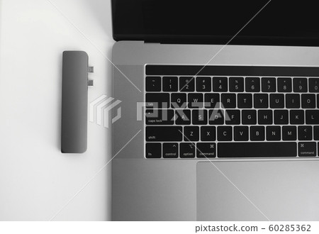 The USB adapter under the Type-C connector for laptop. Multiport station for laptop with multiple different ports. USB to USB Type-C Hub Converter. Gadgets for use a modern laptop. 60285362