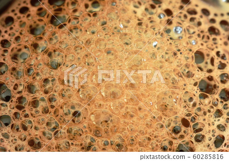 black hot coffee with bubble floating in cup 60285816