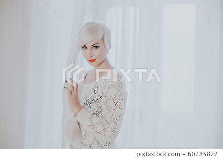 French blonde in a white room fashion 60285822
