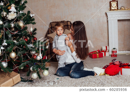 mother and little boy at Christmas tree with gifts 1 mother and little boy at Christmas tree with gifts 1 60285936
