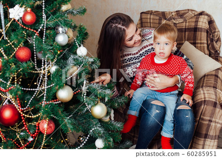 mom with son decorate tree on new year's Gifts Christmas mom with son decorate tree on new year's Gifts Christmas 60285951