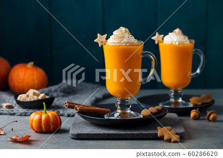 Pumpkin latte with spices. Boozy cocktail with whipped cream on slate board. Grey background. Copy space. Pumpkin latte with spices. Boozy cocktail with whipped cream on slate board. Grey background. Copy space. 60286620