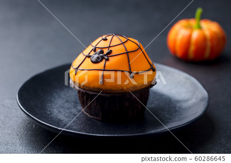 Halloween cupcakes with colourful decoration. Black slate background. Close up. Halloween cupcakes with colourful decoration. Black slate background. Close up. 60286645