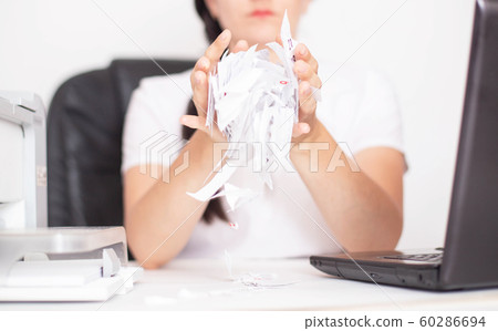 Caucasian girl office worker tears paper on the table. The concept of burnout and depression in the workplace, stress 60286694