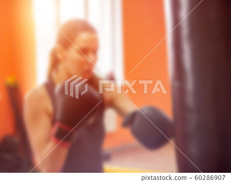The beautiful girl is engaged in martial arts and beats on a punching bag, sunset, blurred, athletic The beautiful girl is engaged in martial arts and beats on a punching bag, sunset, blurred, athletic 60286907