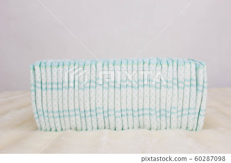 A stack of baby diapers on a white background, protection against leakage and comfort, copy space, lightness 60287098