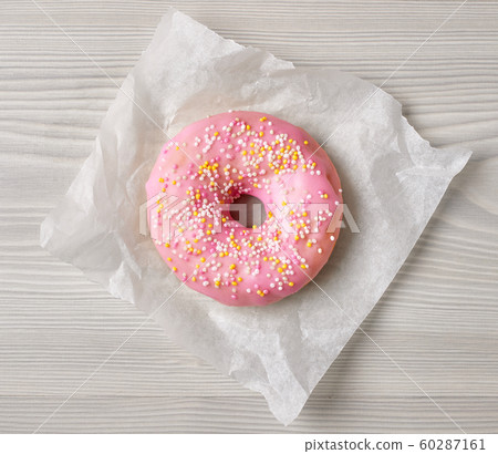 freshly baked donut on grey wooden desk, top view freshly baked donut on grey wooden desk, top view 60287161
