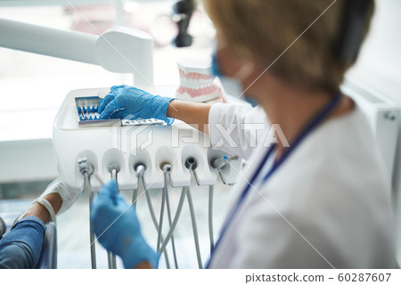 Dentist is taking instruments for checking-up 60287607