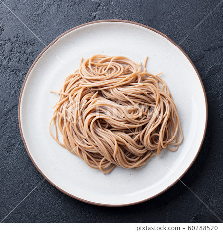 Soba noodles on a white plate. Japanese food. Black slate background. Top view. 60288520