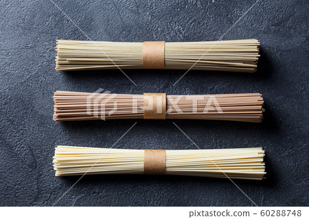 Assortment of asian soba, green tea and egg noodles. Slate background. Top view. 60288748