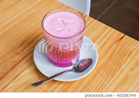 Coffee latte with colorful foam on the wooden table. 60288749