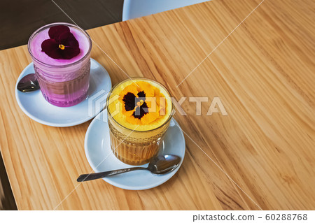 Two glasses of coffee latte with colorful foam Two glasses of coffee latte with colorful foam 60288768