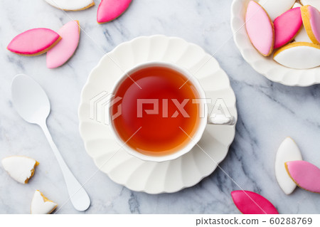 Cup of tea with calissons. Traditional French Provence dessert. Top view. Marble background. Cup of tea with calissons. Traditional French Provence dessert. Top view. Marble background. 60288769