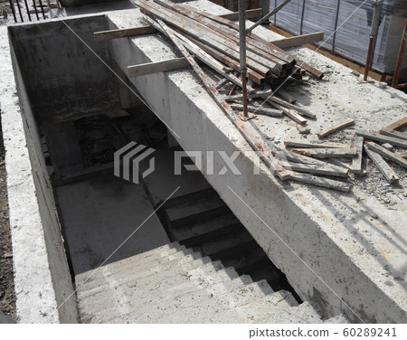 Concrete staircase under construction at the construction site. Timber formwork fabricated by construction workers as the staircase mold. Concrete staircase under construction at the construction site. Timber formwork fabricated by construction workers as the staircase mold. 60289241