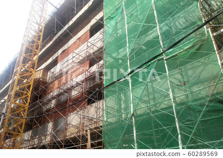 Plastic or nylon netting erected at the external of the under-construction building to prevent construction debris from falling down. Temporary installed. 60289569