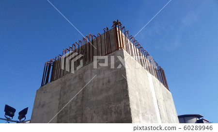Reinforcement concrete column as part of building structure at the construction site. Constructed by workers using timber and metal formwork as a mold.   60289946