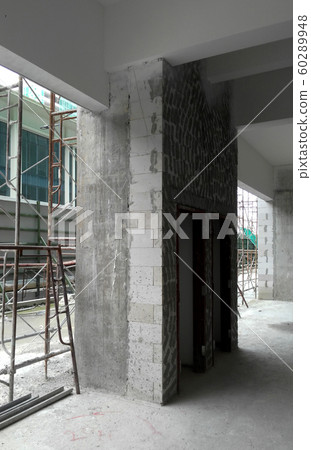 Reinforcement concrete column as part of building structure at the construction site. Constructed by workers using timber and metal formwork as a mold.   60289948