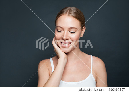 Beautiful young woman with healthy clear skin Beautiful young woman with healthy clear skin 60290171