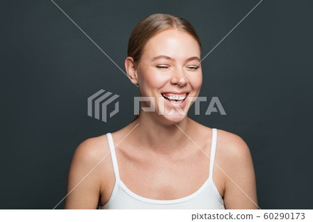 Laughing girl on gray background. Happy young 60290173