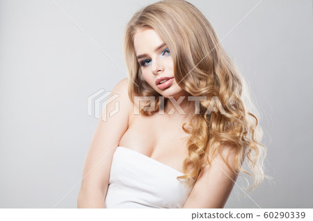 Blonde woman in white dress on white Blonde woman in white dress on white 60290339